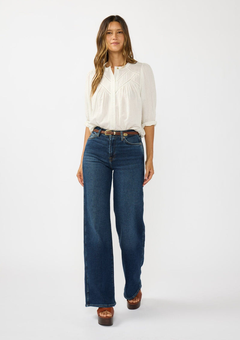 [Color: Cream/Black] A front facing image of a brunette model wearing a boho striped button front blouse with a pintuck yoke, lattice trim, and voluminous sleeves. 