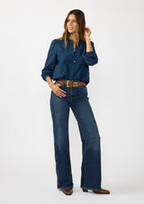 [Color: Navy] A front facing image of a brunette model wearing a navy blue button up blouse with a diamond lattice pattern and long sleeves with button cuffs. A versatile top for the office and weekend casual outings. 