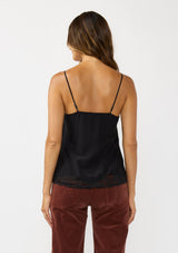 [Color: Black] A back facing image of a brunette model wearing a black cami with lace trims on the neck and hem, adjustable spaghetti straps, and a v-neckline. 
