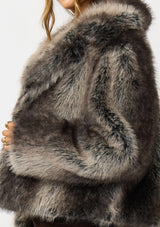 [Color: Charcoal] A detail image of a brunette model wearing an ombre charcoal faux fur coat with a chic collar and cozy fit. Perfect for fall to winter styling. 