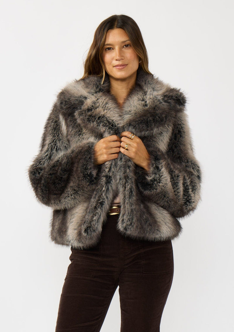 [Color: Charcoal] A front facing image of a brunette model wearing an ombre charcoal faux fur coat with a chic collar and cozy fit. Perfect for fall to winter styling. 