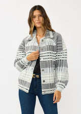 [Color: Grey/Cream] A front facing image of a brunette model wearing a soft and fuzzy grey plaid bomber jacket with a collared neckline, button front, and side pockets. 