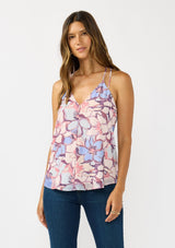 [Color: Natural/Dusty Blue] A front facing image of a brunette model wearing a pink and blue floral tank top with a tie back and racerback detail. A flowy chiffon top for the fall season. 
