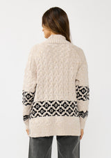 [Color: Natural/Black] A back facing image of a brunette model wearing a marled knit cardigan with a trendy diamond pattern, an open front, and ribbed border. A southwestern inspired knit cardigan with a boho relaxed fit. 