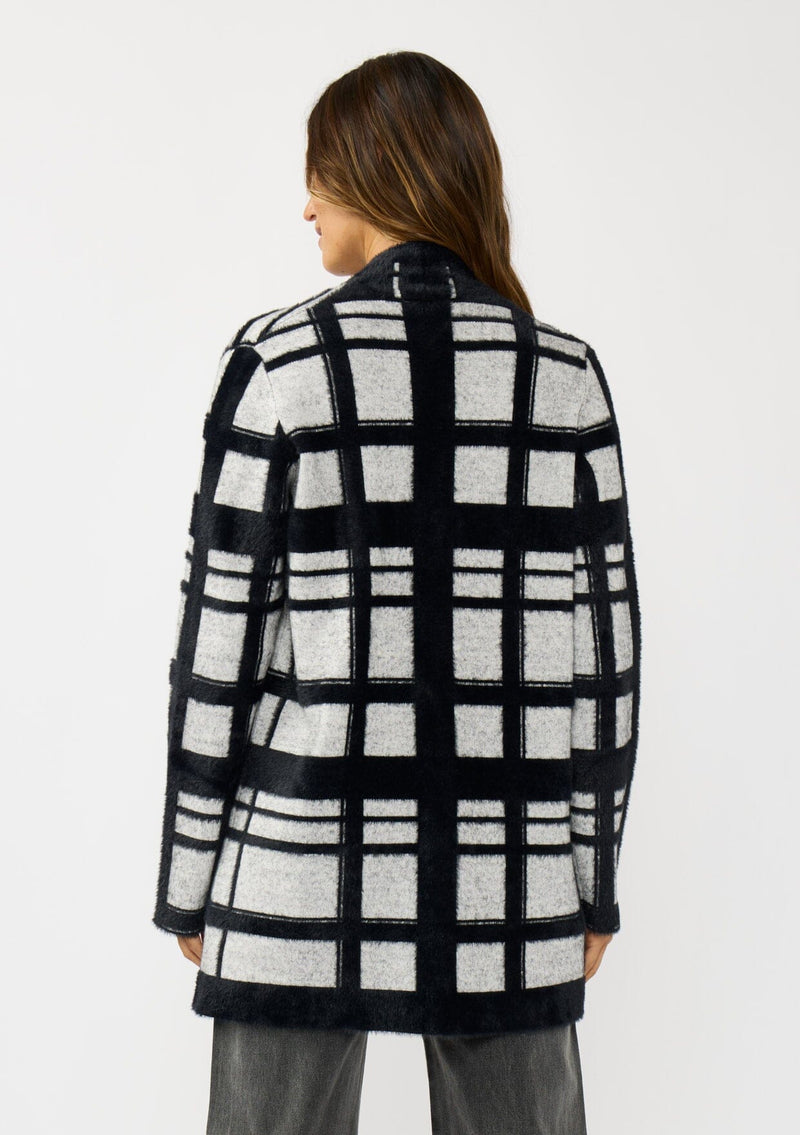 [Color: Black/Grey] A back facing image of a brunette model wearing a black and grey fuzzy plaid cardigan with an open front and patch pockets. A cozy cardigan for the fall season. 