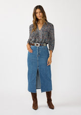 [Color: Navy/Rose] A front facing image of a brunette model wearing a navy floral blouse with 3/4 length sleeves, a split v-neckline, and front pintuck details. A classic boho blouse for casual outings. 
