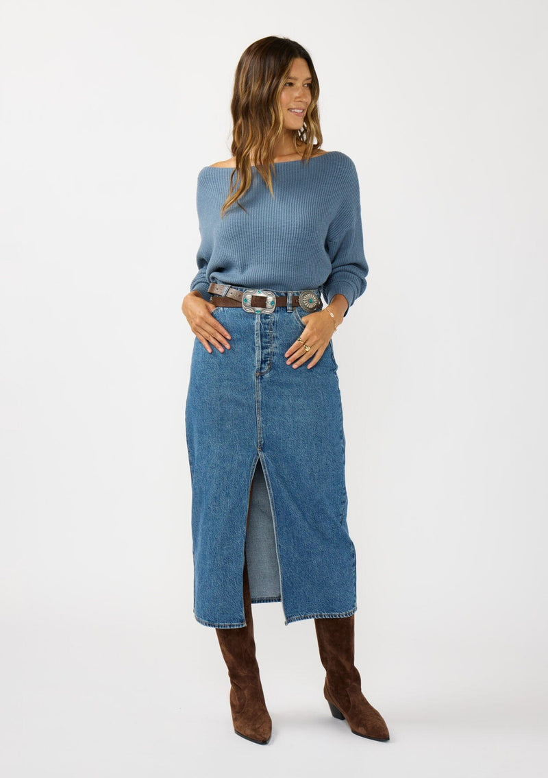 [Color: Cream] A front facing image of a brunette model wearing a blue waffle knit pullover sweater. With long sleeves, a relaxed fit, and a wide neckline that can be worn off the shoulder.