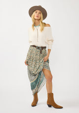 [Color: Taupe/Dusty Teal] A front facing image of a blonde model wearing a green teal floral bohemian skirt with an elastic drawstring waist and lace detail. A classic bohemian skirt for the fall season. 