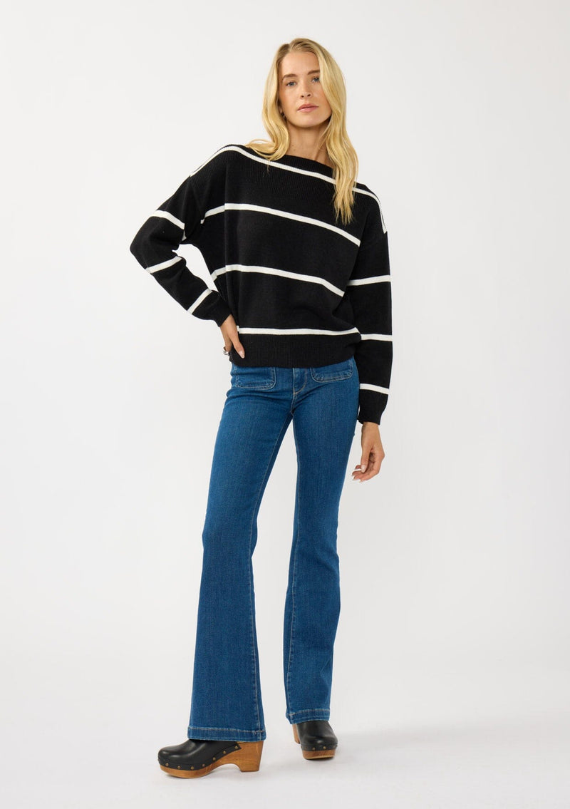 [Color: Black/White] A blonde model wearing a classic black and white striped knit pullover sweater. With long sleeves, a boat neckline, and ribbed trims. Perfectly relaxed and boxy for everyday styling. 