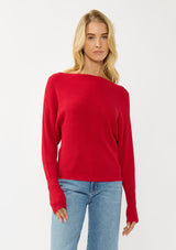 [Color: Red] A front facing image of a blonde model wearing a red waffle knit pullover sweater. With long sleeves, a relaxed fit, and a wide neckline that can be worn off the shoulder.