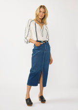 [Color: White/Black] A front facing image of a blonde model wearing a white cotton top with black embroidered details. A classic boho top with a split v-neckline, button front, and long sleeves.  