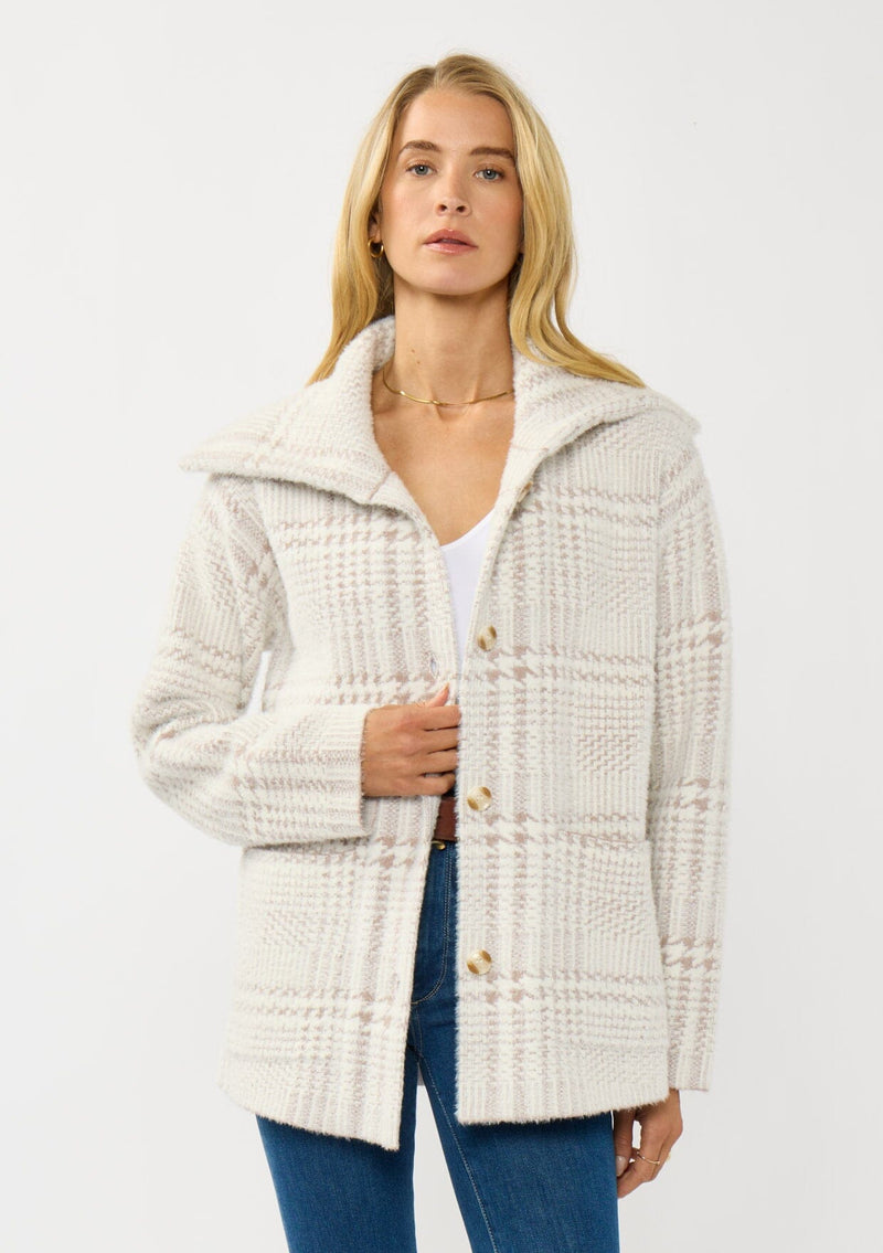 [Color: Cream/Taupe] A front facing image of a blonde model wearing a plaid cozy sweater jacket with a wide collared neckline, button front, and front pockets. Cozy and fuzzy for the fall and winter season. 