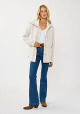 [Color: Cream/Taupe] A front facing image of a blonde model wearing a plaid cozy sweater jacket with a wide collared neckline, button front, and front pockets. Cozy and fuzzy for the fall and winter season. 
