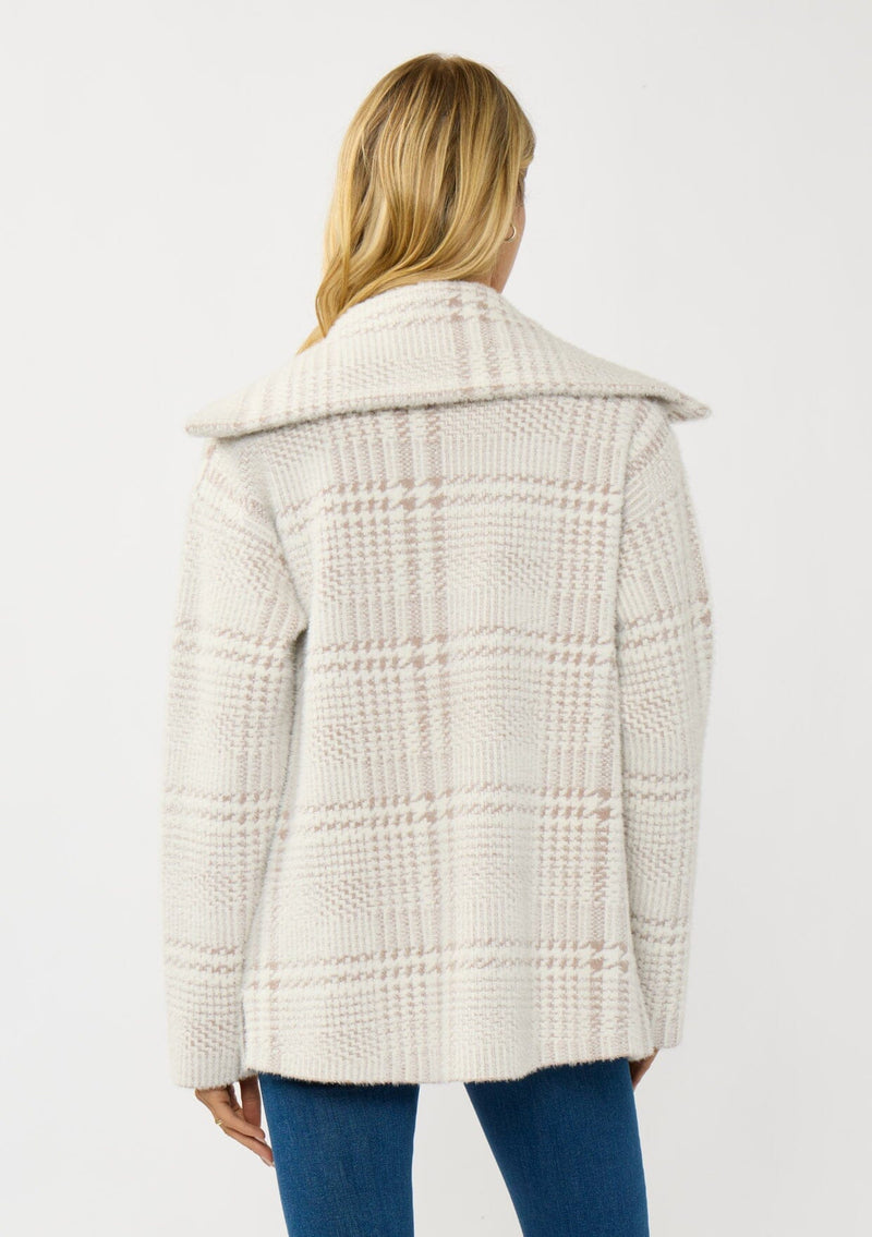 [Color: Cream/Taupe] A back facing image of a blonde model wearing a plaid cozy sweater jacket with a wide collared neckline, button front, and front pockets. Cozy and fuzzy for the fall and winter season. 