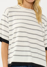 [Color: Off White/Black] A detail image of a blonde model wearing a white striped sweater tee with a crew neckline, short sleeves, and a chic contrast trim. A relaxed top for casual lounge days. 