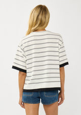 [Color: Off White/Black] A back facing image of a blonde model wearing a white striped sweater tee with a crew neckline, short sleeves, and a chic contrast trim. A relaxed top for casual lounge days. 