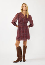 [Color: Wine/Rose] A front facing image of a blonde model wearing a floral diamond print chiffon mini dress with metallic thread details, 3/4 sleeves, a button front, and an elastic waist. A special occasion dress for weddings and holidays. 