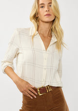 [Color: Natural/Silver] A front facing image of a blonde model wearing an off white windowpane shirt with metallic thread details. Featuring a collared neckline, button front, and button button cuff closure. A western influence shirt for the fall season. 