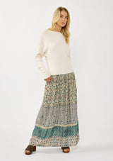 [Color: Natural] A front facing image of a blonde model wearing an off white waffle knit pullover sweater. With long sleeves, a relaxed fit, and a wide neckline that can be worn off the shoulder.