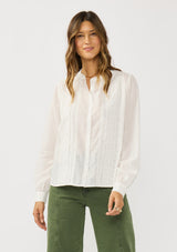 [Color: White] A front facing image of a brunette model wearing a white blouse with lace details, button front, and button cuffs. 