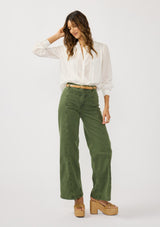 [Color: White] A front facing image of a brunette model wearing a white blouse with lace details, button front, and button cuffs. 