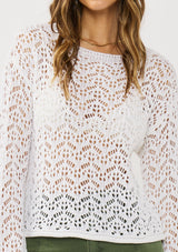 [Color: White] A detail image of a brunette model wearing a white crochet knit top with a round neckline and long sleeves. A breezy pullover for the beach or casual outings. 