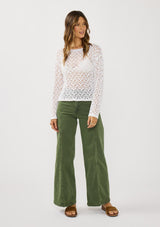 [Color: White] A front facing image of a brunette model wearing a white crochet knit top with a round neckline and long sleeves. A breezy pullover for the beach or casual outings. 