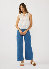 [Color: White] A front facing image of a brunette model wearing a white tank top with lace and eyelet detailing. 