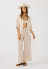 [Color: Sand/White] A front facing image of a brunette model wearing a beige striped top and bottom set for vacation and resort styling. 