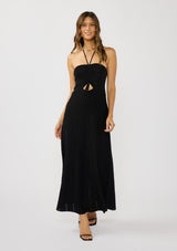[Color: Black] A front facing image of a brunette model wearing a black knit halter dress with pointelle detail. Featuring a chic halter neckline, ruched bust with adjustable ties, and a front cutout. 
