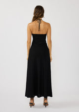[Color: Black] A back facing image of a brunette model wearing a black knit halter dress with pointelle detail. Featuring a chic halter neckline, ruched bust with adjustable ties, and a front cutout. 