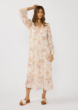 [Color: Natural/Dusty Rose] A front facing image of a brunette model wearing a pink floral chiffon midi dress with a flowy silhouette, long sleeves, smocked bib, smocked back, and tiered skirt. An effortless and romantic floral dress  for the spring season.