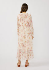 [Color: Natural/Dusty Rose] A back facing image of a brunette model wearing a pink floral chiffon midi dress with a flowy silhouette, long sleeves, smocked bib, smocked back, and tiered skirt. An effortless and romantic floral dress  for the spring season.