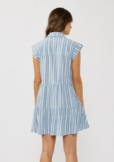 [Color: Blue/White] A back facing image of a brunette model wearing a blue striped mini dress with tiered skirt, short dolman sleeves, collared neckline, button front, and a single patch pocket. 