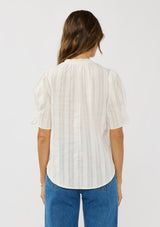 [Color: White] A back facing image of a brunette model wearing a white button up puff sleeve top with a jacquard stripe and  metallic thread details. 