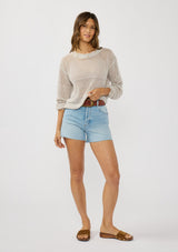 [Color: Stone] A front facing image of a brunette model wearing a grey knit top with silver metallic thread, a round neck, long sleeves, and open knit details. 