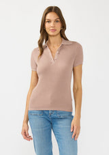 [Color: Rose Dust] A front facing image of a brunette model wearing  a waffle knit polo top with a collared neck and button front. 