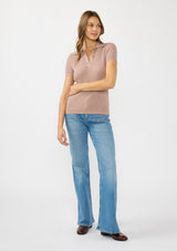 [Color: Rose Dust] A front facing image of a brunette model wearing  a waffle knit polo top with a collared neck and button front. 