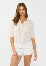 [Color: Natural/Cream] A front facing image of a brunette model wearing a white embroidered puff sleeve top with a button front. 