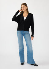 [Color: Black] A front facing image of a brunette model wearing a black button front cardigan with long dolman sleeves, a v neckline, and rib trims. 