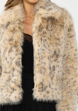 [Color: Leopard] A detail image of a brunette model wearing a leopard faux fur coat with a collar and an open front. 