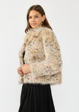 [Color: Leopard] A side facing image of a brunette model wearing a leopard faux fur coat with a collar and an open front. 