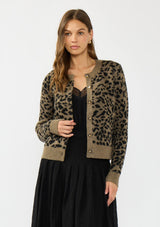 [Color: Brown] A front facing image of a brunette model wearing a brown leopard print cardigan with a button front, round neckline, and a contrast ribbed border. 