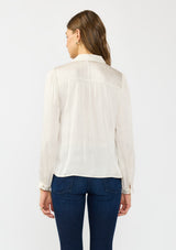 [Color: Eggshell] A back facing image of a brunette model wearing a white satin blouse with a collar, v-neckline, button front, and long sleeves. 
