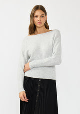 [Color: Heather Lunar] A front facing image of a brunette model wearing a light grey pullover sweater with an off shoulder design, boat neckline, and ribbed cuffs. 