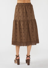 [Color: Brown] A back facing image of a brown embroidered midi skirt. 