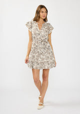 [Color: Cream/Black] A front facing image of a brunette model wearing a cream and black floral mini dress with flutter sleeves, a split v neckline, lace trims, and a self tie waist belt. 
