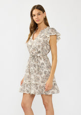 [Color: Cream/Black] A side facing image of a brunette model wearing a cream and black floral mini dress with flutter sleeves, a split v neckline, lace trims, and a self tie waist belt. 