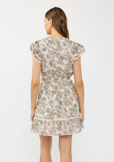 [Color: Cream/Black] A back facing image of a brunette model wearing a cream and black floral mini dress with flutter sleeves, a split v neckline, lace trims, and a self tie waist belt. 