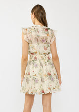 [Color: Ivory/Rosewood] A back facing image of a brunette model wearing an ivory floral mini dress with flutter cap sleeves, a button front, smocked waist, and a tiered skirt with ruffle trims.